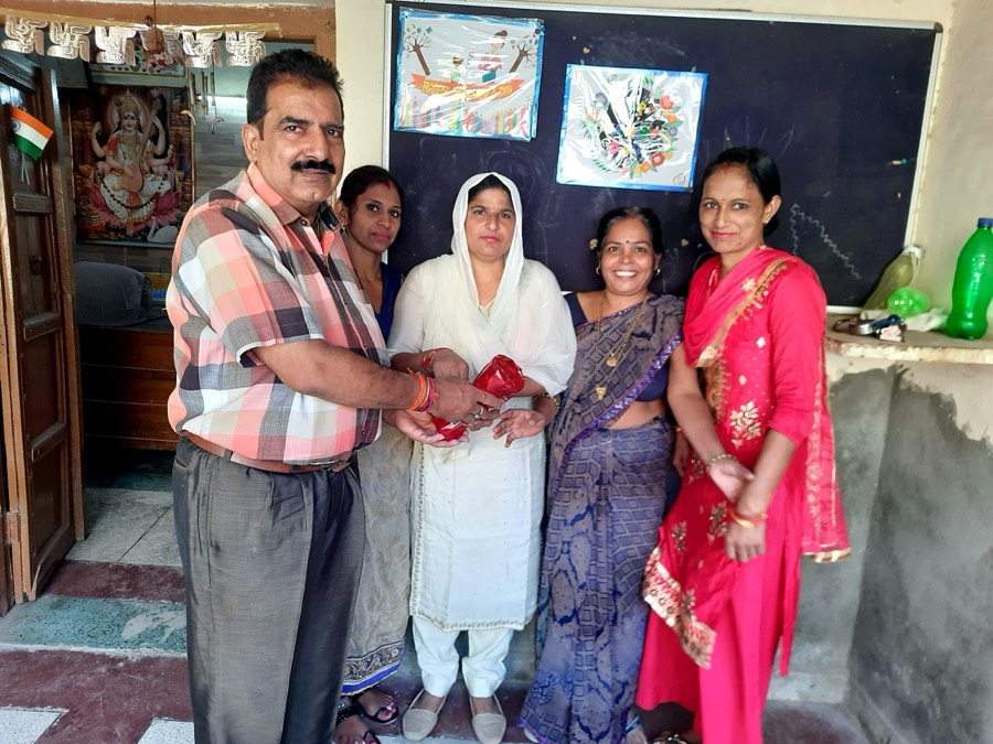 Foundation representatives with a teacher during a handover
